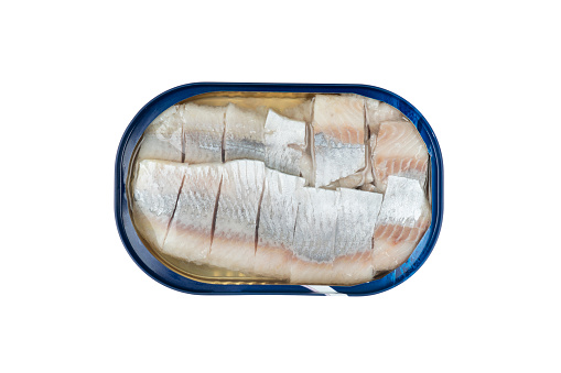 Herring fish in a metal jar isolated on a white background with clipping path. Top view. Herring in a metal can with oil. Salted canned herring isolated