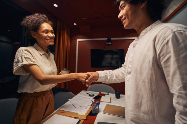 istock American employee is shaking hands with colleague 1344212215