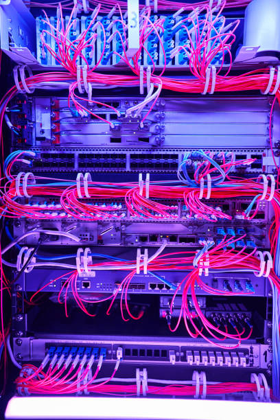 istock Arrangement of red fiber optic cables in server hardware 1344212310