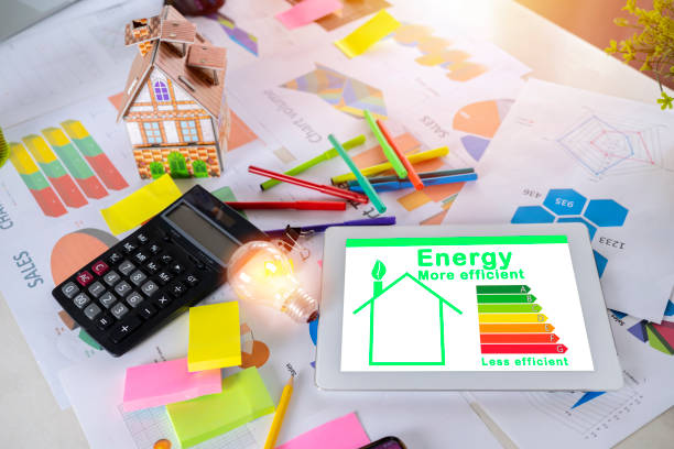 istock Energy efficiency rating graph on a desk with a house model, calculator 1344215384