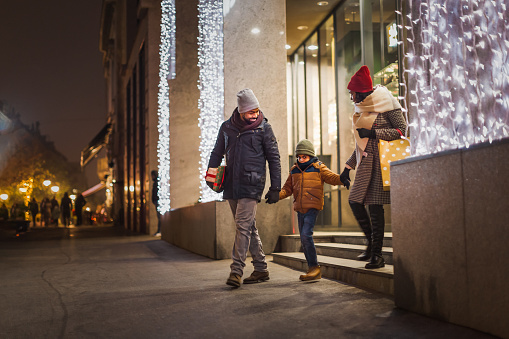 A black family in Christmas shopping, leaving shopping mall