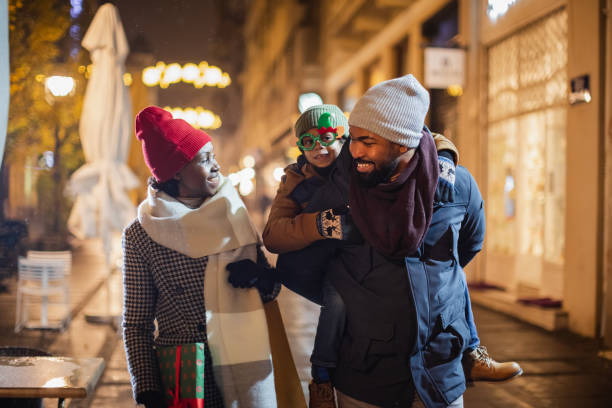 istock Family walking Christmas decorated streets 1344216502