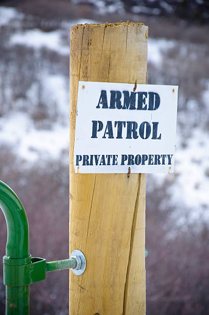 istock Private Property Boundary with Armed Patrol Sign Warning 134421787