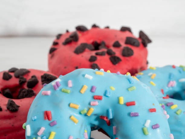 istock Red and blue cronuts on a white wooden background. 1344217919