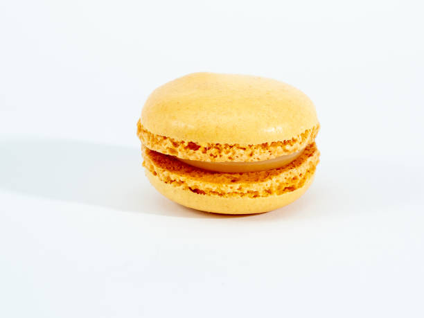 istock Sweet lemon macarons isolated on white background. 1344218124