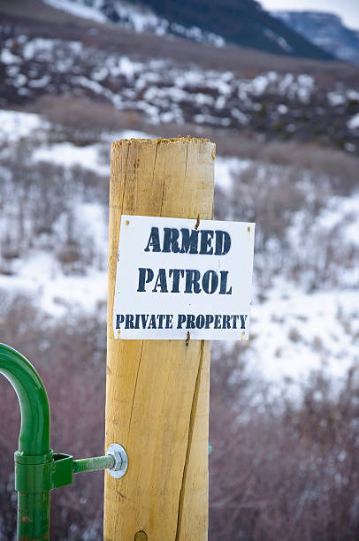 istock Private Property Boundary with Armed Patrol Sign Warning 134421825