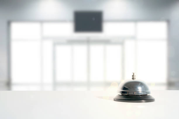 istock Hotel service bell on a table white glass and simulation hotel background. 1344219298