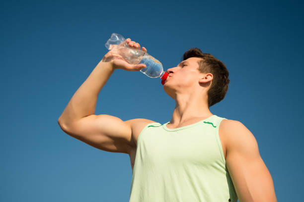 istock Man drinking water from bottle on sunny day 1344220943