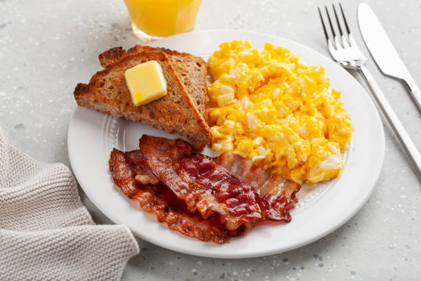 istock traditional scrambled egg breakfast with bacon and toast 1344221048