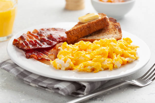 istock traditional scrambled egg breakfast with bacon and toast 1344221050