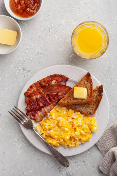 istock traditional scrambled egg breakfast with bacon and toast 1344221084