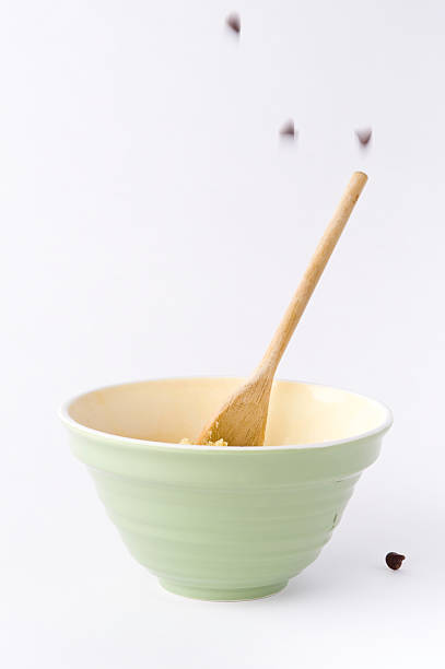 Falling Chocolate Chips and Mixing Bowl Ingredients stock photo