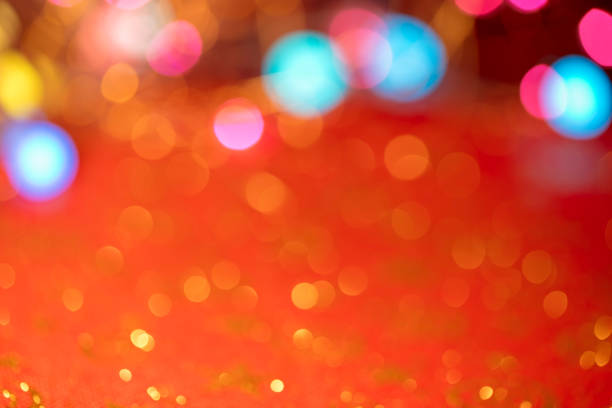 Defocused Christmas lights with beautiful lights bokeh. Red background with space for copy.