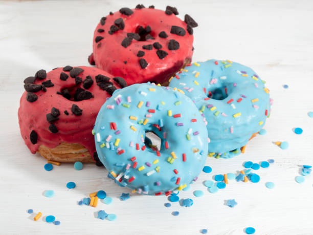 istock Red and blue cronuts on a white wooden background. 1344228232