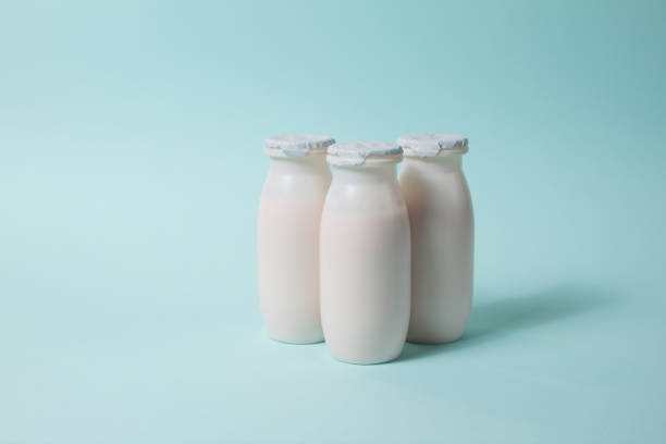 istock Bottles with probiotics and prebiotics dairy drink on light blue background. 1344228411