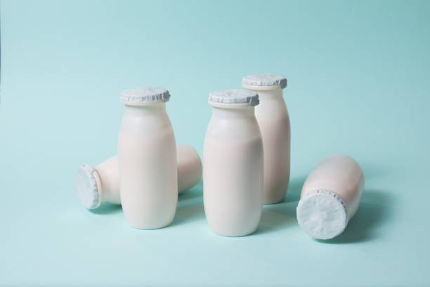istock Bottles with probiotics and prebiotics dairy drink on light blue background. 1344228619