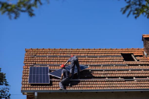 istock Two solar panel installers mounting solar panels on roof of house 1344229579