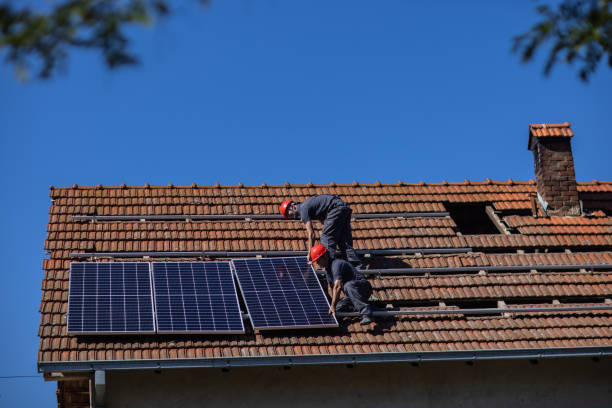 istock Two solar panel installers mounting solar panels on roof of house 1344229778