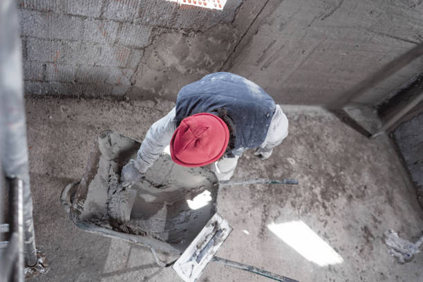 istock Real construction worker working on a wall inside the new house. 1344231405