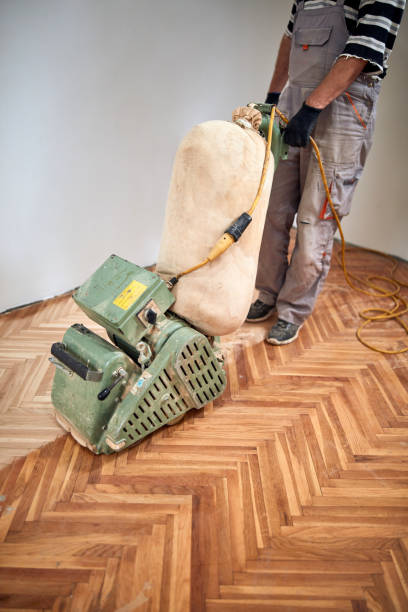 istock Repairman restoring parquet with a sanding machine. 1344231496