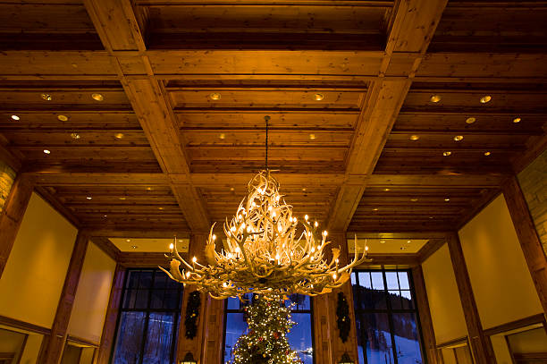 Antler Chandelier in Room with View at Dusk Antler Chandelier in Room with View at Dusk.  ProPhoto RGB. antler chandelier stock pictures, royalty-free photos & images