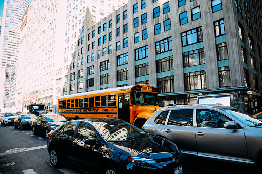 New York, USA - 03 24 2018: Yellow school bus in Manhattan New York City. Yellow school bus was especially formulated in North America in 1939.