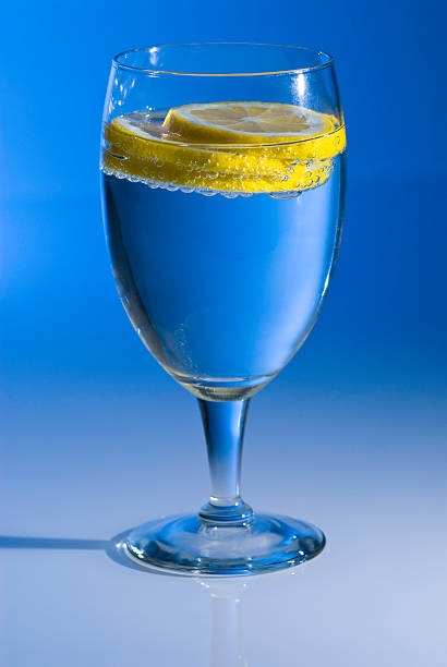 Blue Glass with Lemon and Sparkling Water Blue Glass with Lemon and Sparkling Water.  ProPhoto RGB. soda water glass lemon stock pictures, royalty-free photos & images