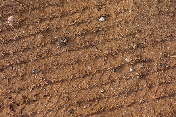 istock Tire Track in Dirt with Broken Glass Background 134423303