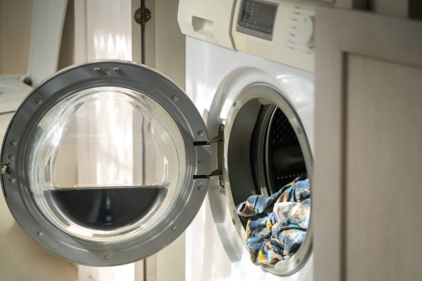 istock Washing machine with open door at home. 1344233502