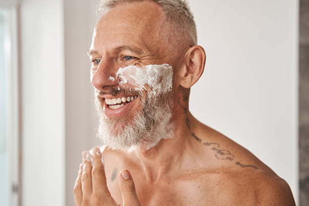 istock Mature man in shaving foam on bearded face 1344233816