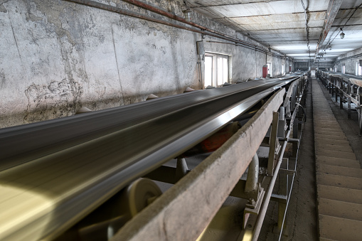 Belt conveyor system in an underground tunnel. Transportation of ore to the surface.