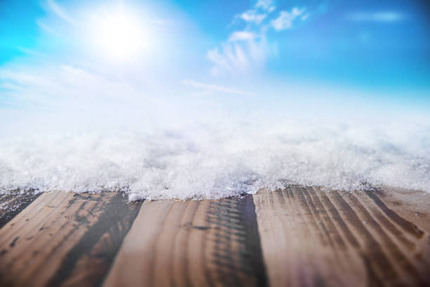 Winter Background - Snowy Wooden Table and Sunny Sky in the Background