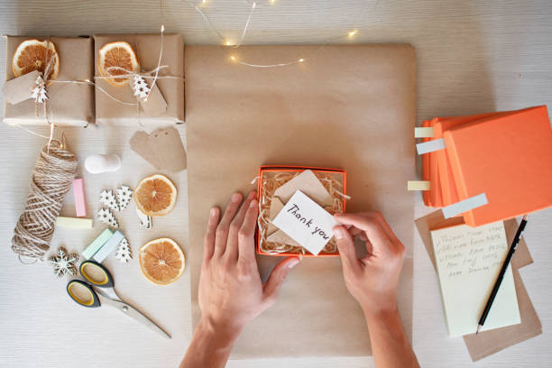 istock Young worker packing Christmas gift boxes for clients, family small business, distant work from home 1344235220