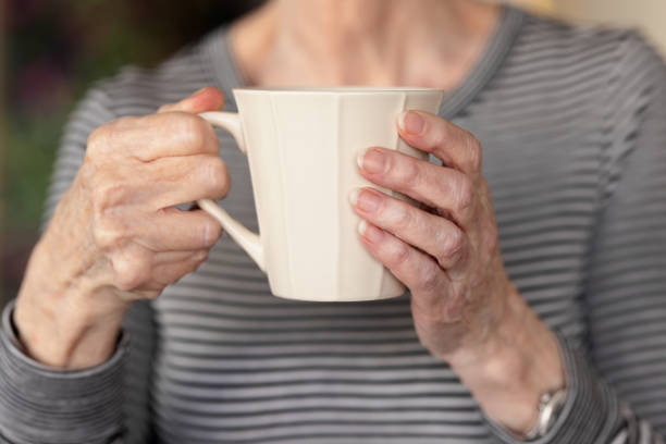 istock Woman holding a coffee cup 1344235251
