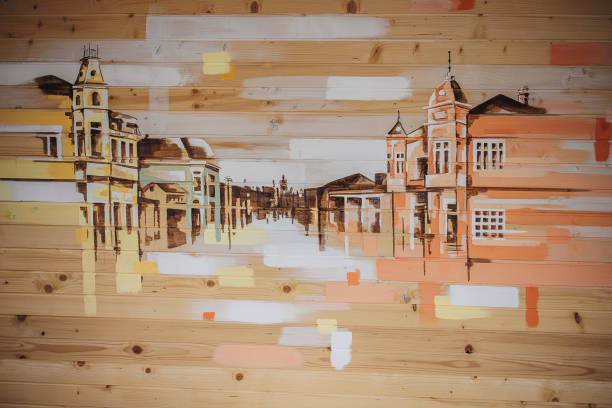 Buildings mural on wooden wall outdoors. No people.