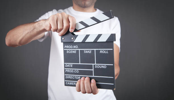istock Man holding movie clapper. Making movie 1344236414
