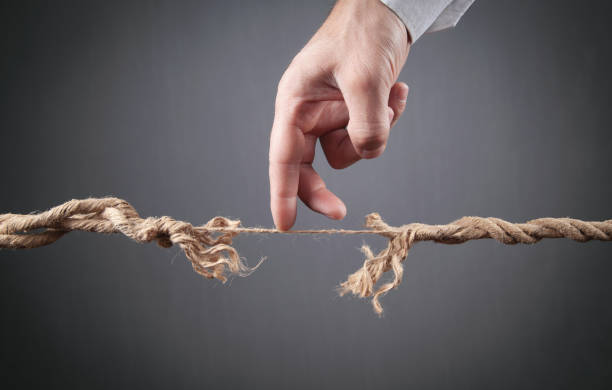 istock Male hand walking a frayed rope. Risk 1344236432