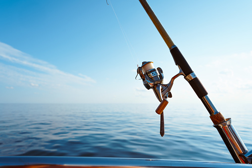 Fishing rod on a sailboat in open sea, close up photo