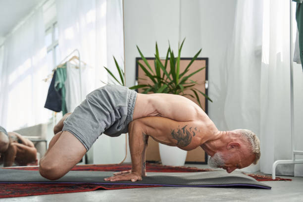 istock Senior man holding his body at the hands while enjoying meditation 1344238988