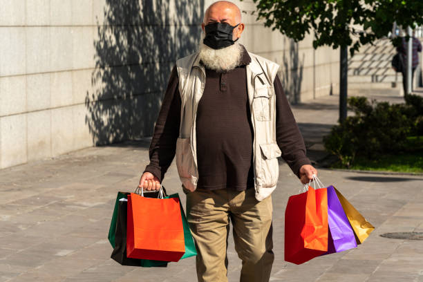 istock Senior man with multiple shopping bags 1344240333