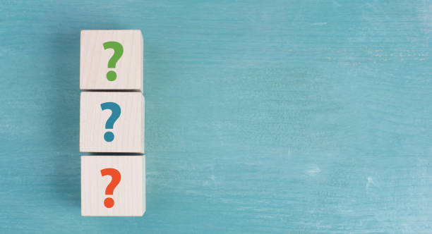 istock Three wooden cubes with question marks in red, blue and green color 1344241980