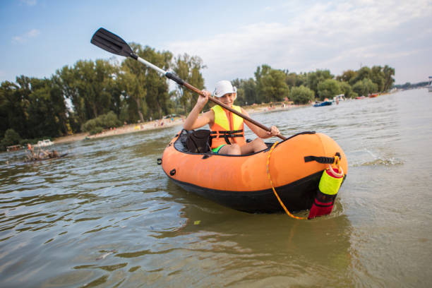 istock Teenager having fun kayaking on a lake 1344243893