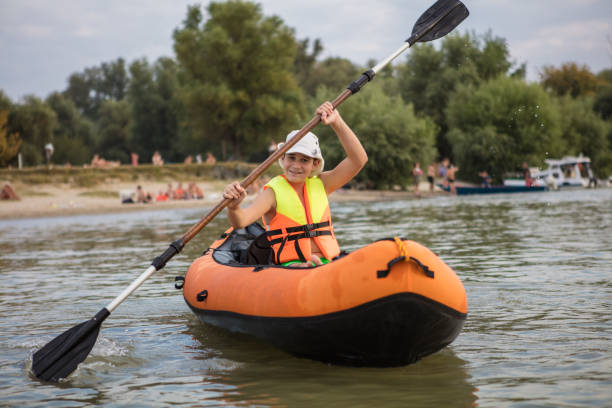 istock Teenager having fun kayaking on a lake 1344244853
