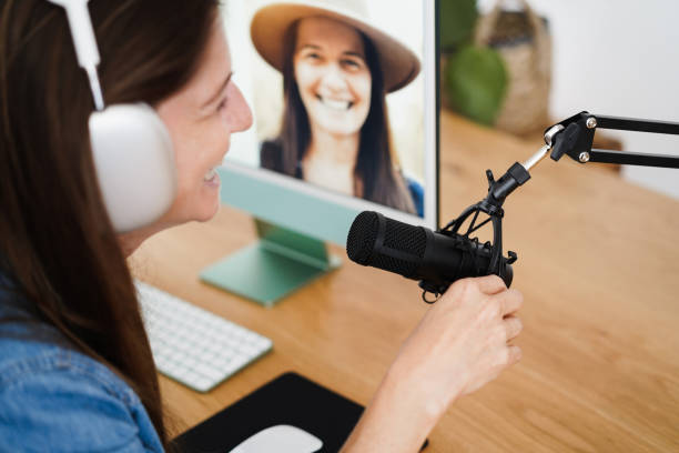 istock Influencer woman doing podcast using computer at home - Technology trend concept - Focus on microphone 1344244870