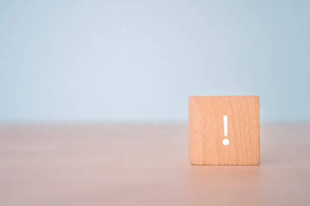 Photo of A wooden block with an exclamation mark.