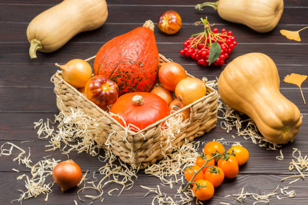 istock Pumpkins and onions in wicker basket. 1344245966