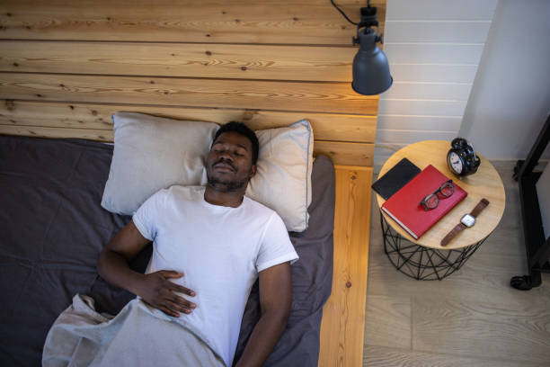 istock Young man sleeping in bed at home 1344246201