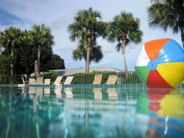 colorful beach ball in swimming pool - swimming pool party summer beach ball imagens e fotografias de stock