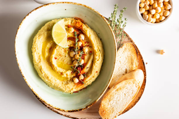 istock Classic hummus with spices and lime in a bowl 1344246683