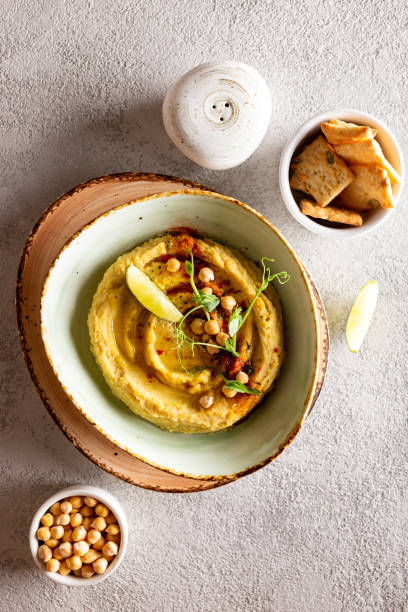 istock Healthy appetizer classic hummus decorated with greens and spices 1344246703